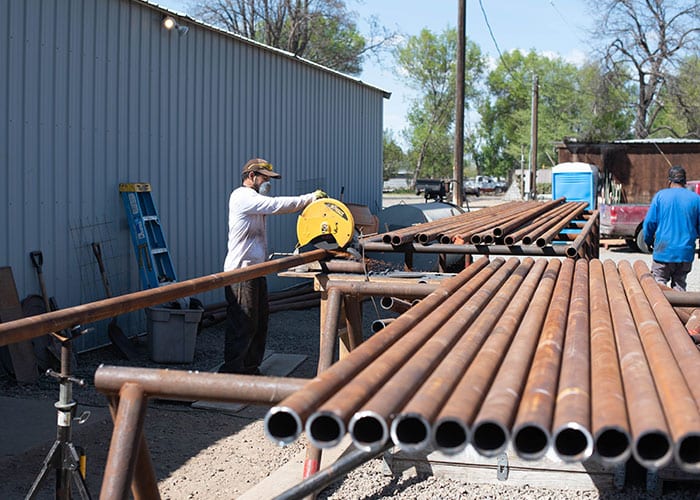 workers cutting well stem pipe