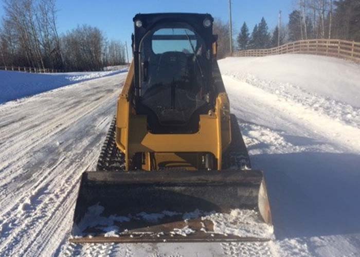 skid steer plowing snow