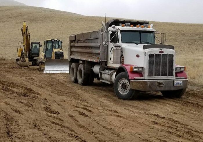 dump truck, bulldozer, and earth mover